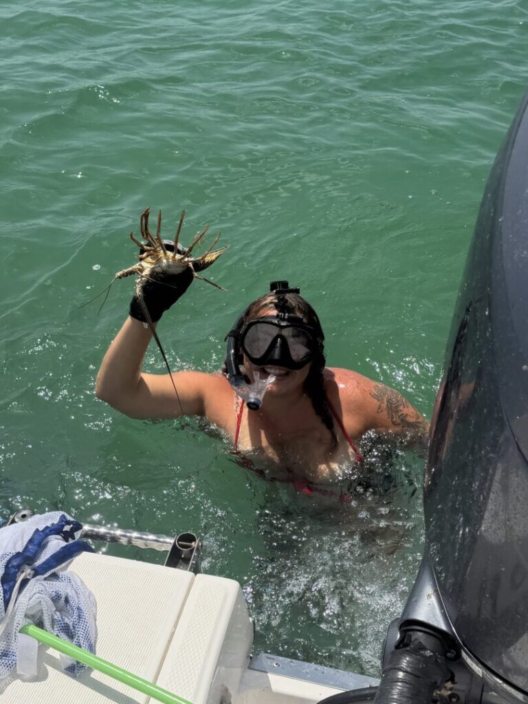 Ceilia snorkeling beside a boat