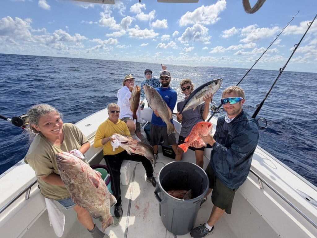 Guests displaying their catches aboard an offshore fishing boat
