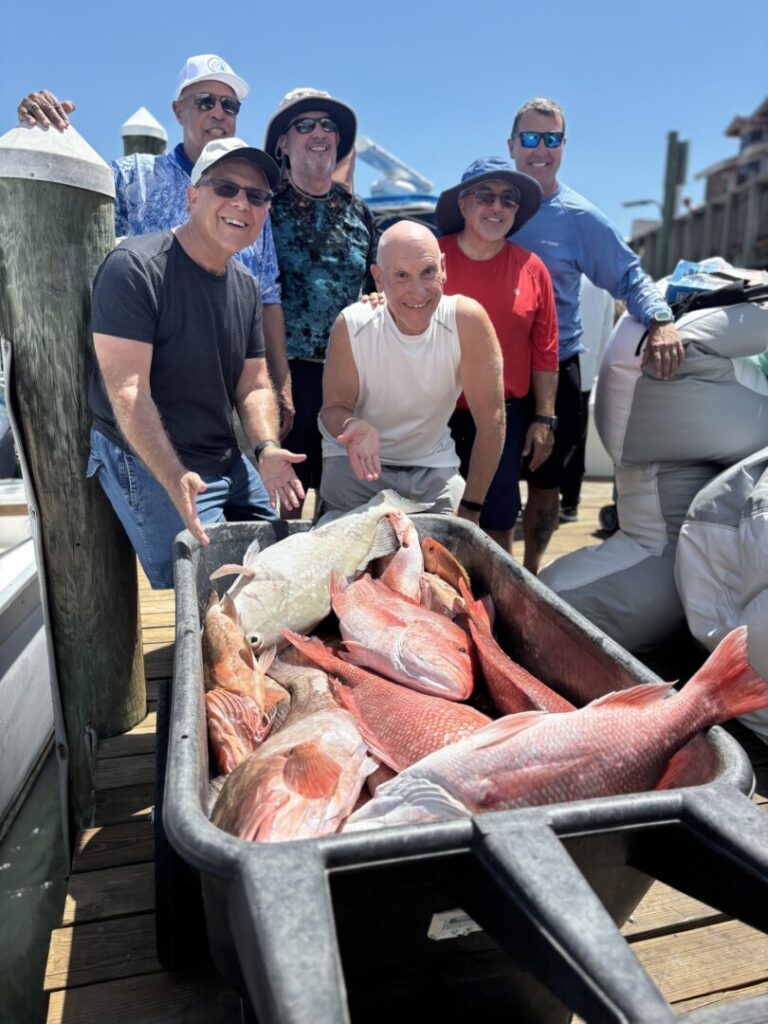 Guests gathered at the dock with their fishing catch