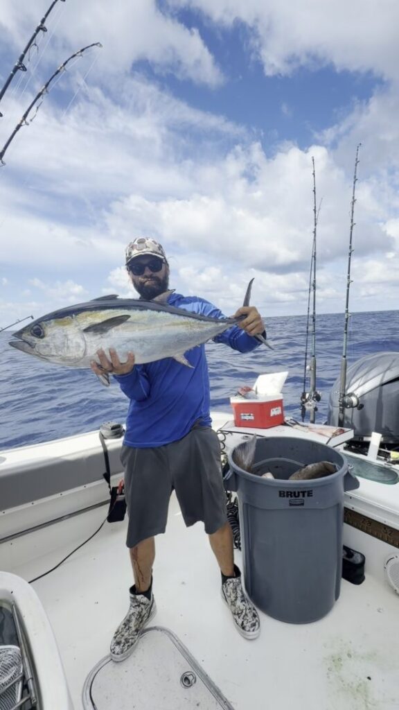 Captain Brandon Vaughan displaying a catch aboard his boat