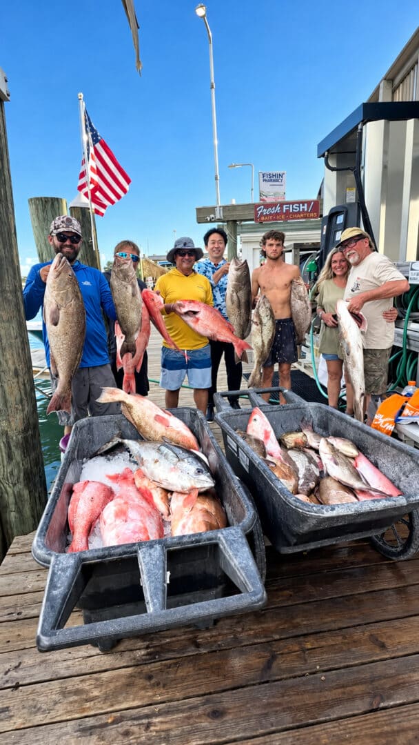 Anglers with a cooler full of fish at the dock